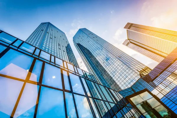 Bottom view of modern skyscrapers in business district in evening light at sunset with lens flare filter effect